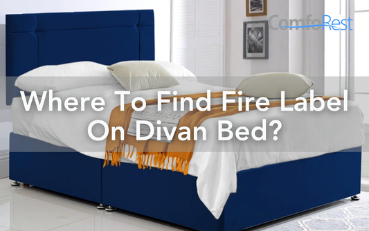 Blue divan bed with pillows and blanket, highlighting where to find the fire safety label on a divan bed.