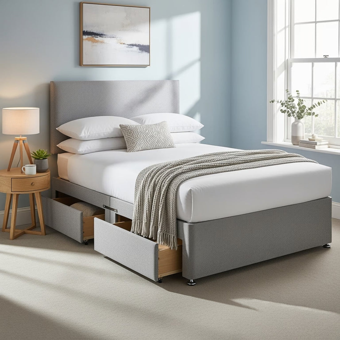 a grey small double divan bed with drawers