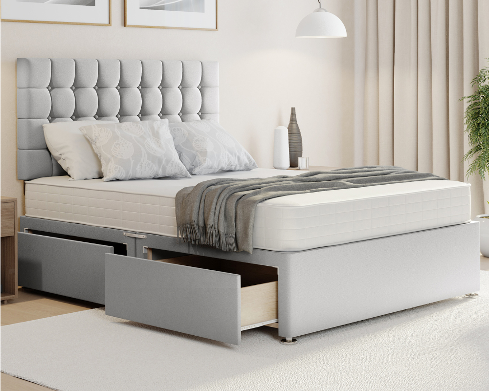 silver plush cubex style divan bed with mattress and storage drawers.