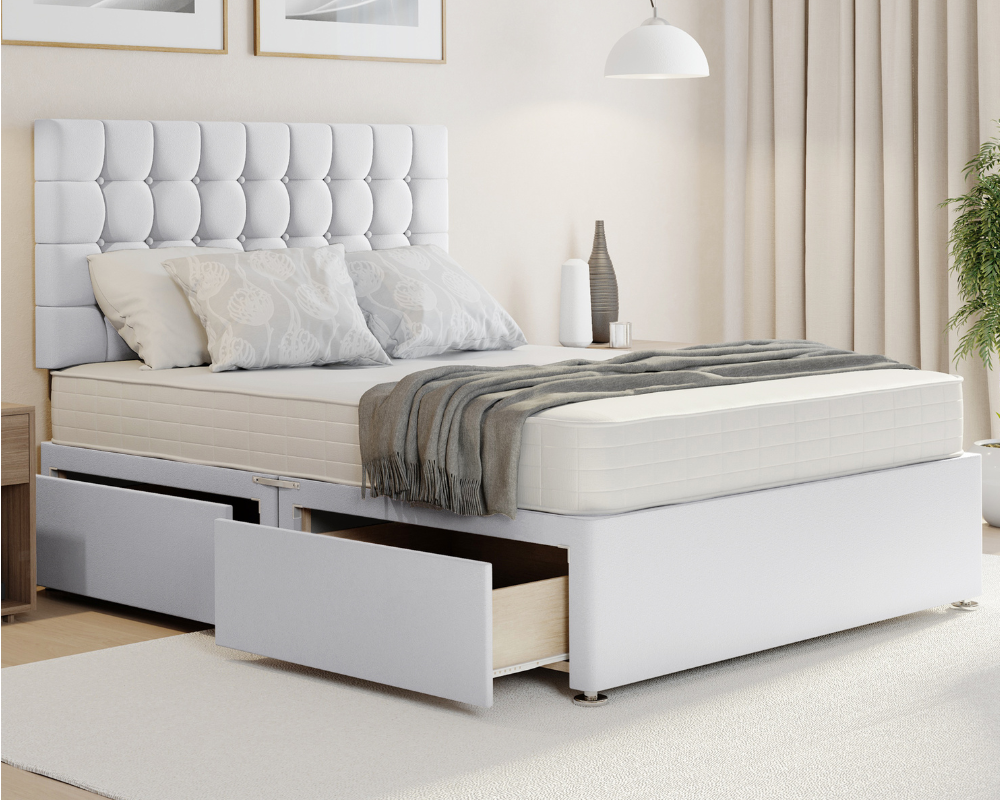 white plush cubex style divan bed with mattress and storage drawers.